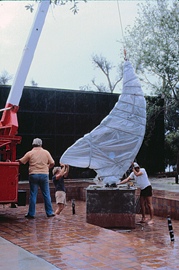 Hal and his fabricators working with crane to erect his stainless steel sculpture "Summer Fall Winter Spring!"  in reflecting pool. 