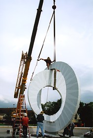 Charles Cook rides high and maneuvers the second disk into place.